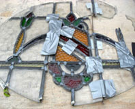 heraldic oval stained glass panel .